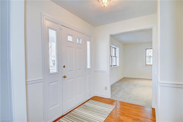 foyer featuring baseboards and wood finished floors