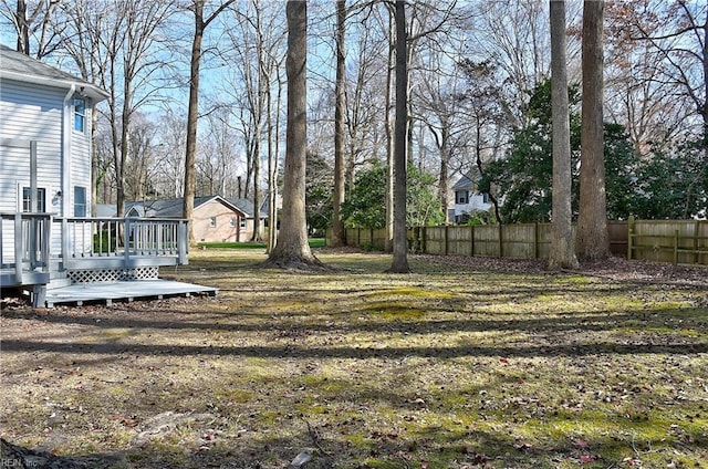 view of yard featuring fence and a wooden deck