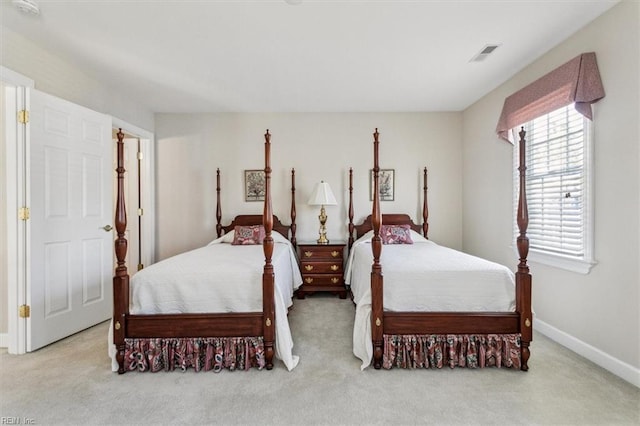 bedroom with carpet floors, visible vents, and baseboards