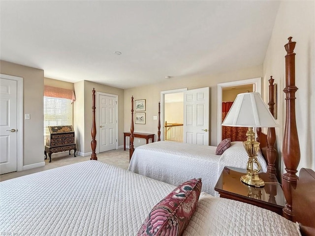 bedroom featuring light carpet and baseboards