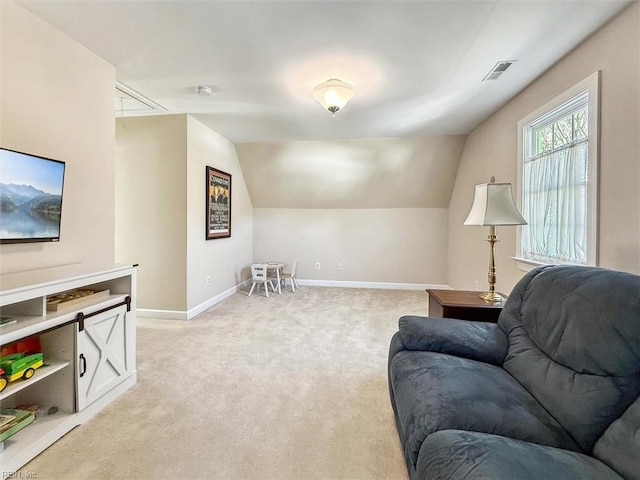 living area with visible vents, vaulted ceiling, light carpet, and baseboards