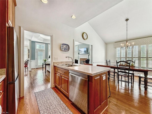 kitchen with dark wood-style floors, appliances with stainless steel finishes, a sink, light countertops, and a wealth of natural light