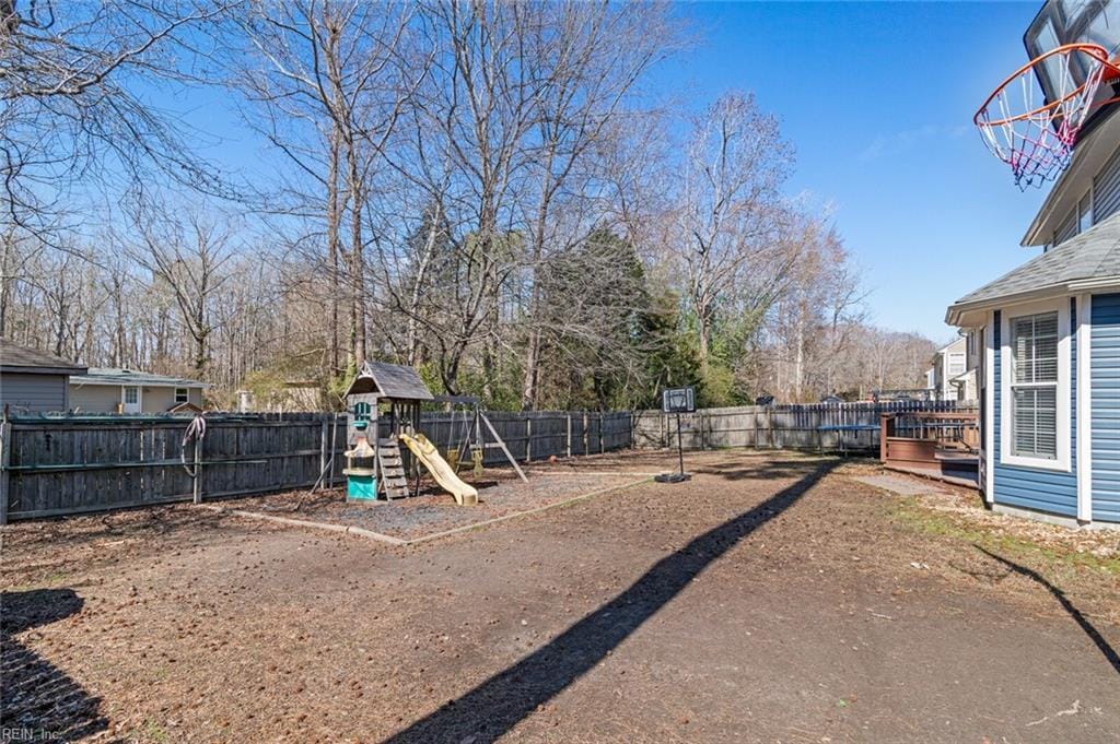 view of yard featuring a fenced backyard and a playground