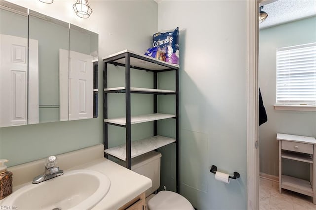 bathroom featuring marble finish floor, vanity, and toilet