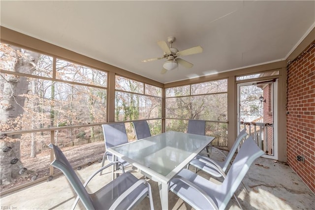 sunroom featuring ceiling fan