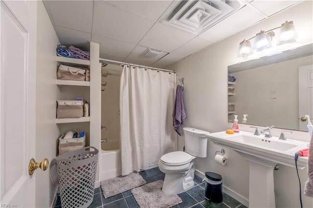 full bath with visible vents, toilet, a sink, tile patterned flooring, and a paneled ceiling