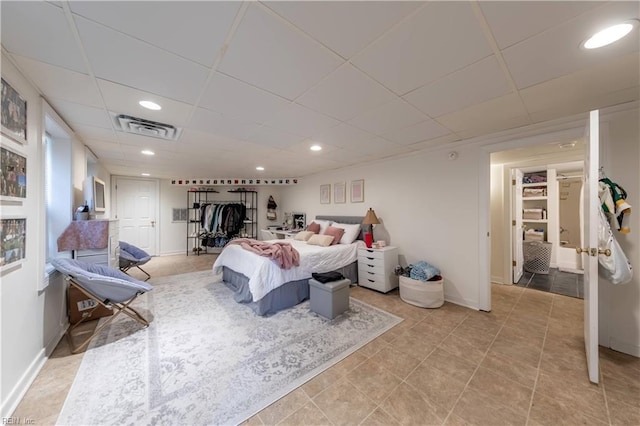 bedroom featuring visible vents, baseboards, a drop ceiling, light tile patterned floors, and recessed lighting