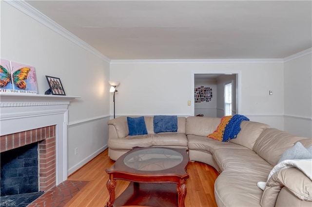 living area featuring a brick fireplace, wood finished floors, and ornamental molding