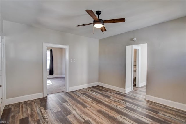 unfurnished room featuring ceiling fan, baseboards, and wood finished floors