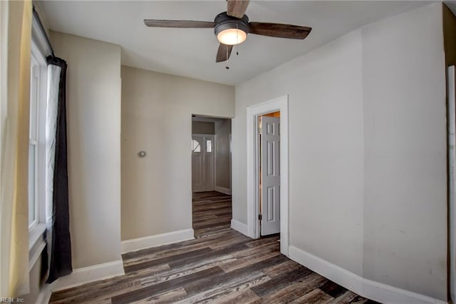 spare room with ceiling fan, baseboards, and wood finished floors