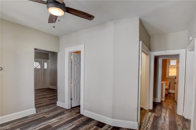 interior space featuring a ceiling fan, baseboards, and wood finished floors