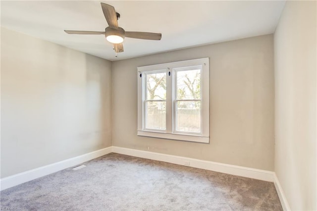 unfurnished room with carpet, ceiling fan, and baseboards