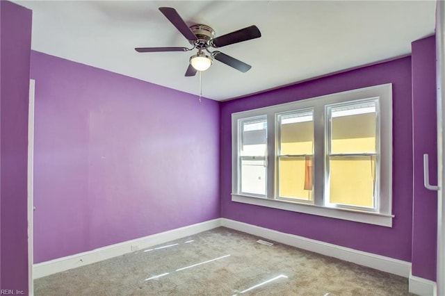 unfurnished room with ceiling fan, carpet, and baseboards