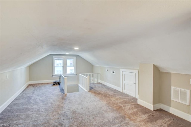 bonus room with carpet, visible vents, and baseboards