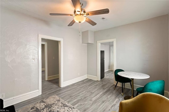 sitting room featuring baseboards, visible vents, and wood finished floors