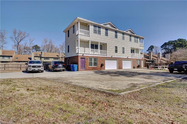 view of front of home featuring concrete driveway, brick siding, and an attached garage