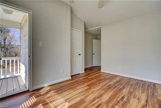 unfurnished room with wood finished floors and baseboards