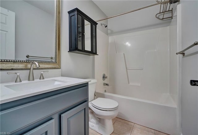 full bath with washtub / shower combination, vanity, tile patterned flooring, and toilet