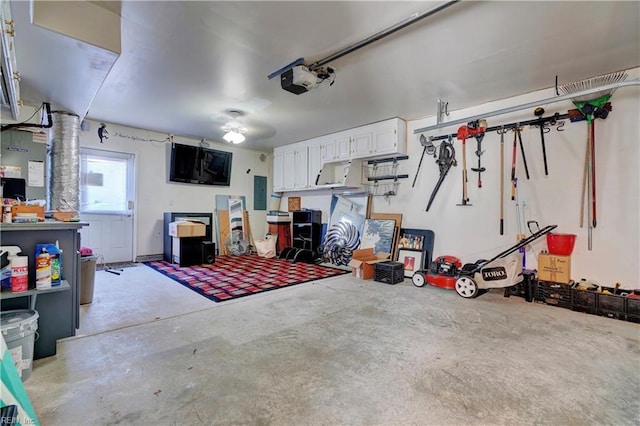 garage featuring electric panel and a garage door opener