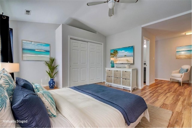 bedroom with light wood-style floors, baseboards, visible vents, and a closet