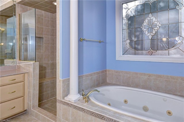 full bathroom with a whirlpool tub, tile patterned flooring, tiled shower, and vanity