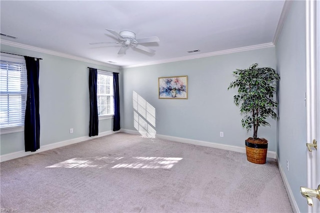 unfurnished room with baseboards, visible vents, carpet flooring, and ornamental molding