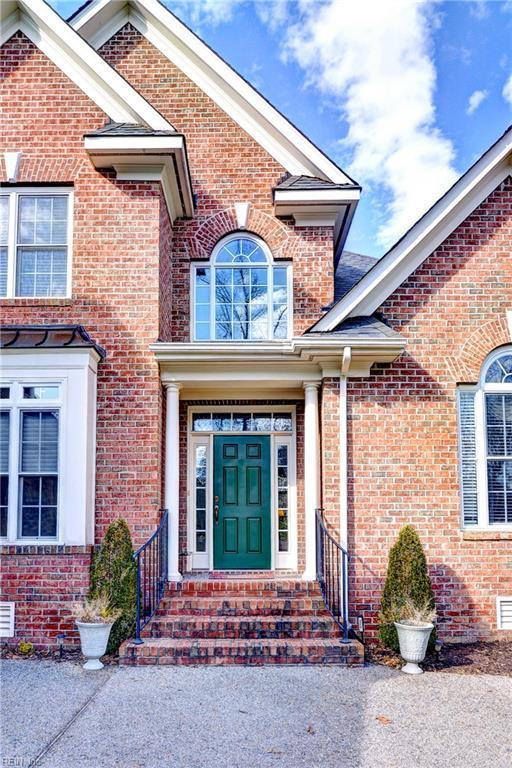 view of exterior entry featuring brick siding