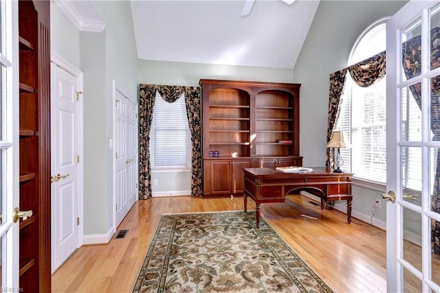 office area featuring baseboards, visible vents, french doors, light wood-style floors, and high vaulted ceiling