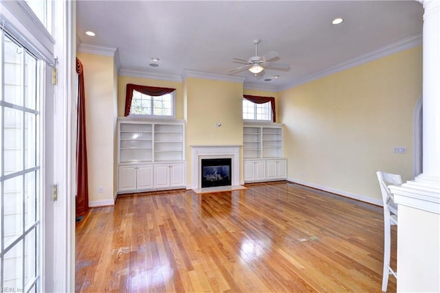 unfurnished living room featuring ornamental molding, a fireplace with flush hearth, light wood-style flooring, and baseboards