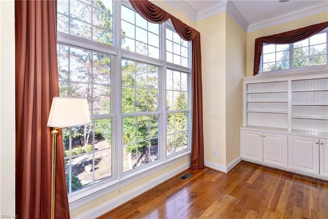 interior space featuring dark wood-style floors, visible vents, crown molding, and baseboards