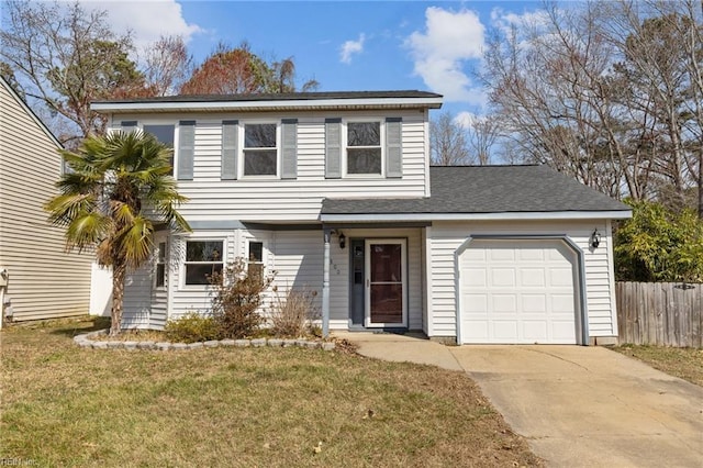 traditional-style house featuring a garage, concrete driveway, a front yard, and fence