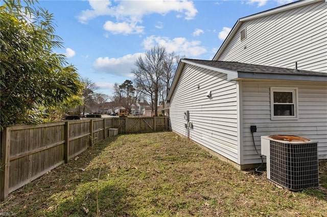 view of yard featuring central air condition unit and a fenced backyard