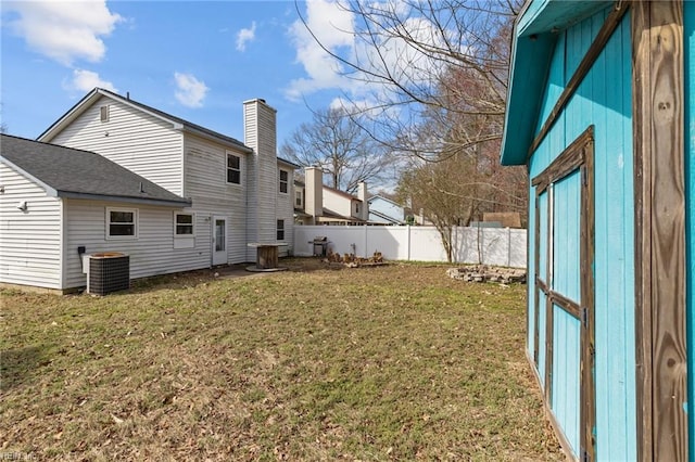 view of yard featuring cooling unit and fence