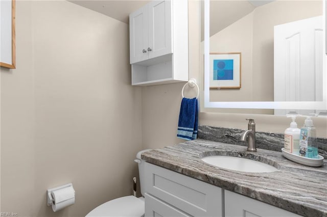 bathroom with toilet and vanity