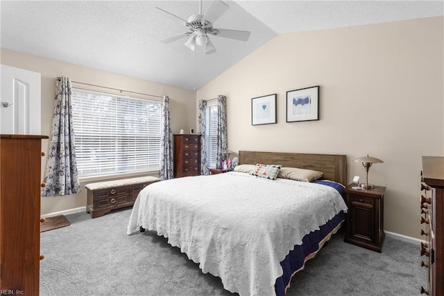 carpeted bedroom featuring vaulted ceiling, ceiling fan, a textured ceiling, and baseboards