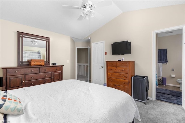 bedroom featuring light colored carpet, connected bathroom, vaulted ceiling, ceiling fan, and baseboards