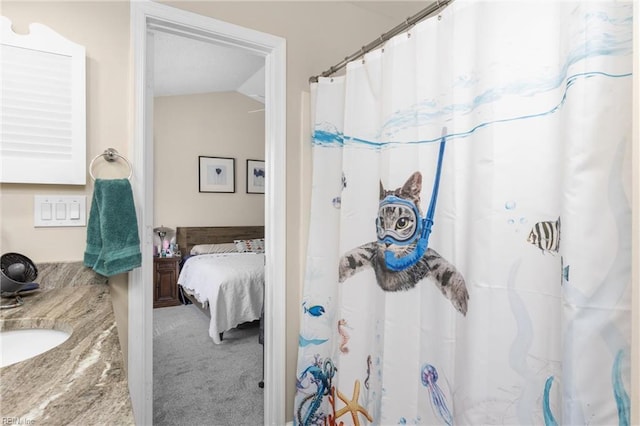 full bath with lofted ceiling, a shower with curtain, and a sink