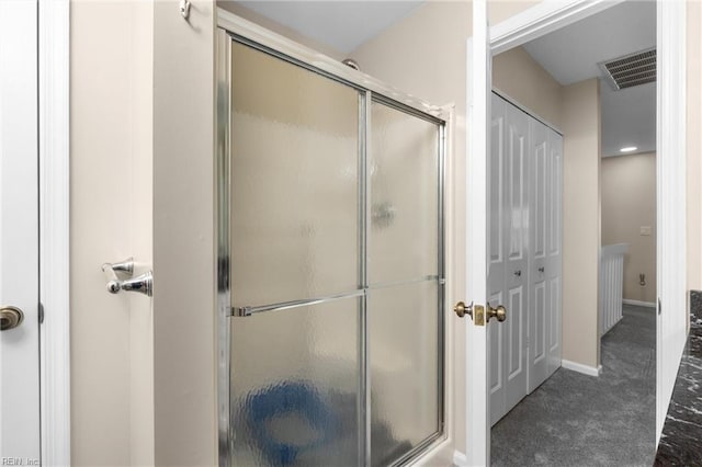 bathroom featuring a stall shower, visible vents, and baseboards