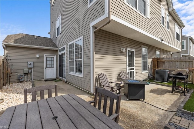 exterior space featuring central AC, a patio area, and fence