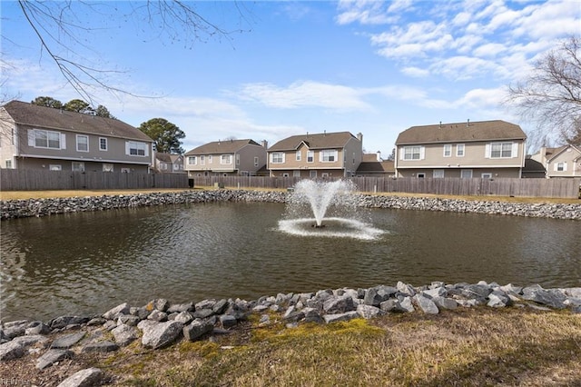 water view with a residential view and fence