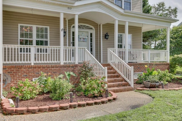 view of exterior entry with a porch