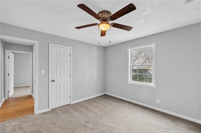 unfurnished bedroom featuring ceiling fan, carpet, and baseboards