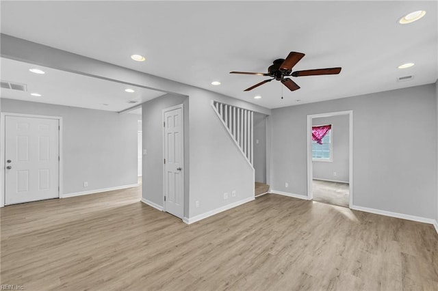 unfurnished living room featuring light wood-style flooring, stairs, visible vents, and recessed lighting