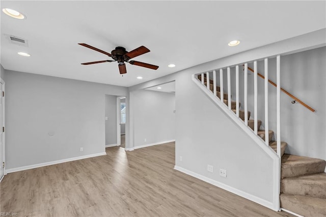 unfurnished living room with stairs, baseboards, wood finished floors, and recessed lighting