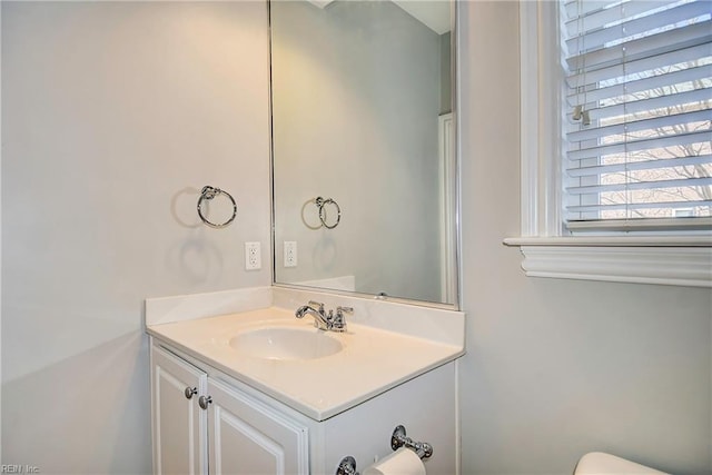 bathroom featuring vanity and toilet