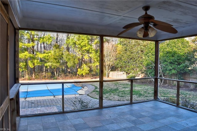 unfurnished sunroom featuring ceiling fan