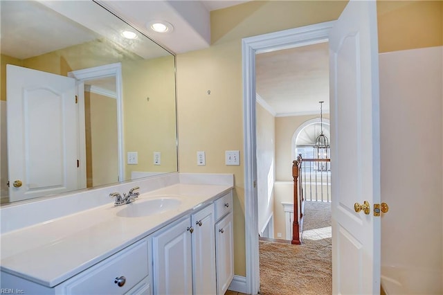 bathroom featuring a notable chandelier, vanity, and crown molding