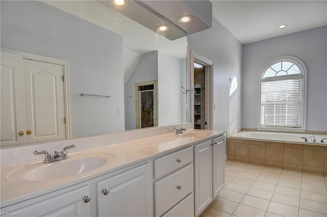 full bathroom featuring a garden tub, tile patterned flooring, a sink, tiled shower, and double vanity