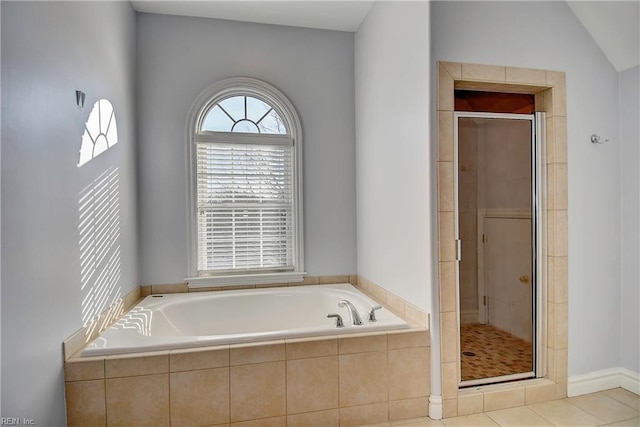 full bathroom with a garden tub, tile patterned floors, vaulted ceiling, and a stall shower