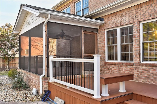 wooden deck featuring fence and a sunroom